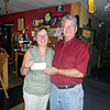 Arlin presenting $200 check to Kathy, daughter of Arnold Dugmore, from the Arnold Dugmore Memorial Shoot.